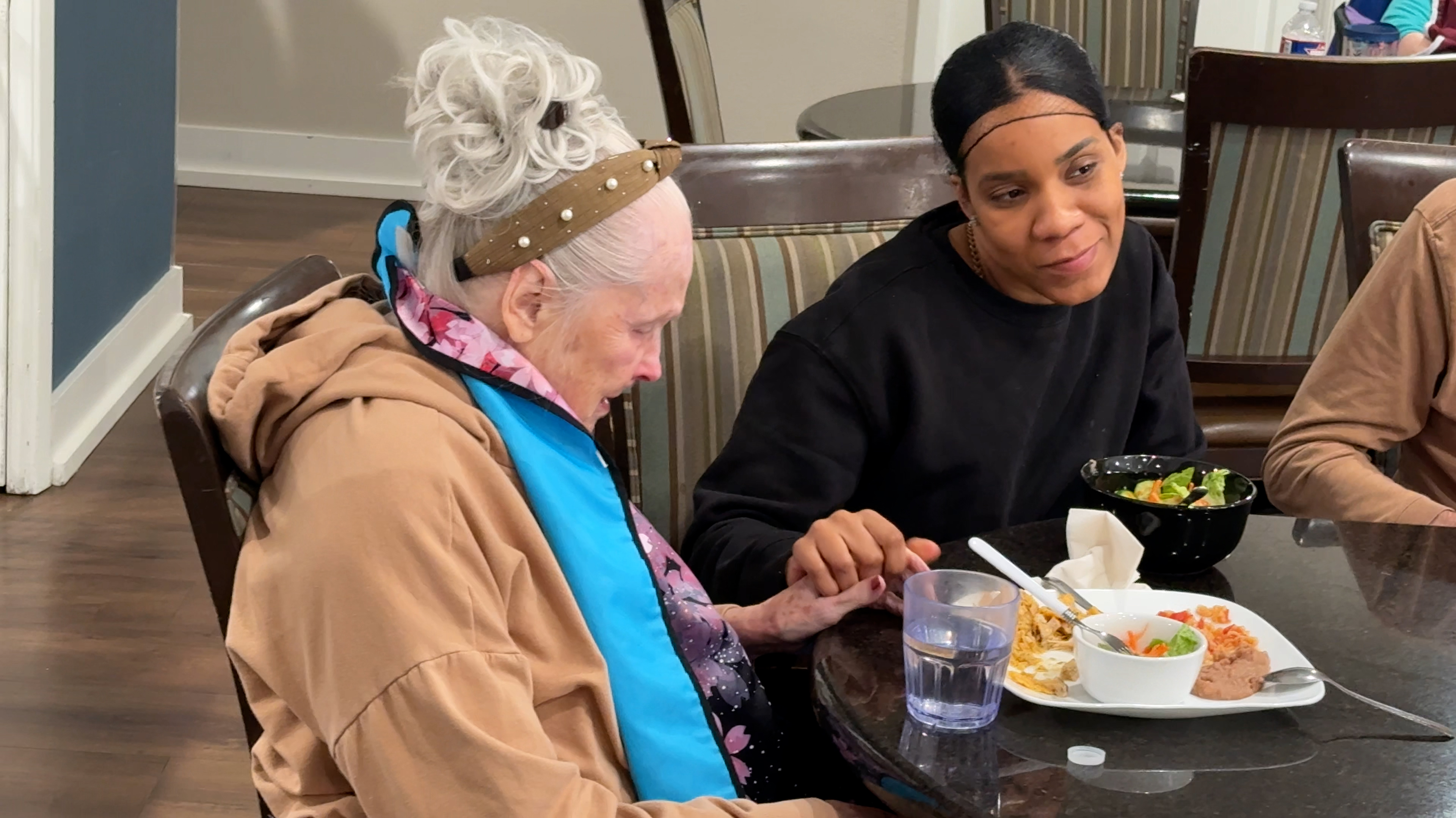 Residents smiling during lunch at SCR